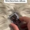 Customized mini photo album keychain with a photo cover, held in hand