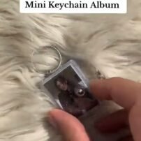 Customized mini photo album keychain with a photo cover, held in hand