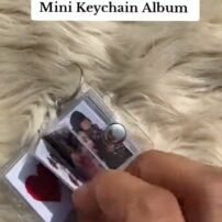 Mini album keychain opened to show printed photo pages inside
