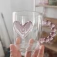 Heart Glass Mug 350ml held in hand showing pink heart design