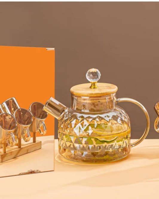 Glass beverage set with jug and glasses on a wooden rack Glass beverage set with jug and glasses on a wooden rack