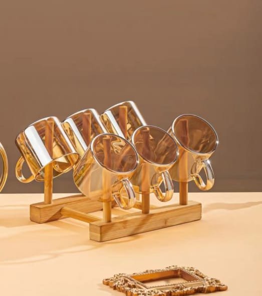 Six glass cups hanging on the wooden stand of the beverage set Six glass cups hanging on the wooden stand of the beverage set