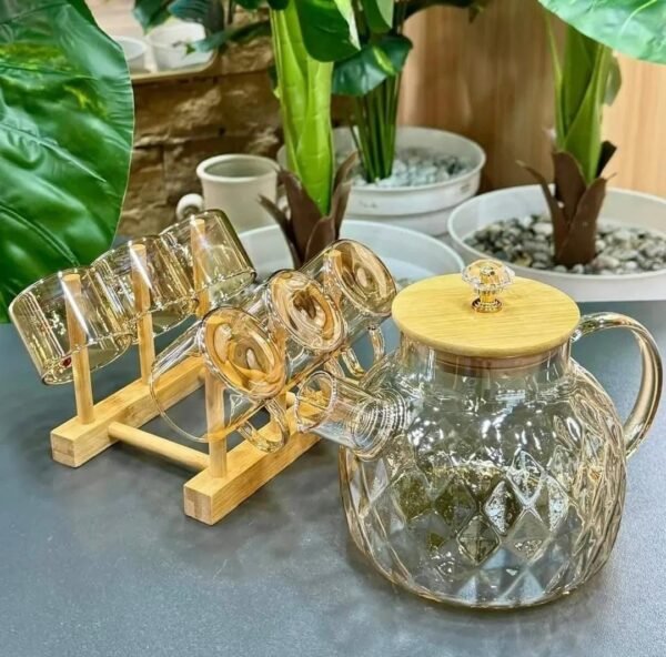 Glass jug set placed on a table with plants in a real home setting Glass jug set placed on a table with plants in a real home setting