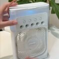 Portable mist cooling fan being used on a desk