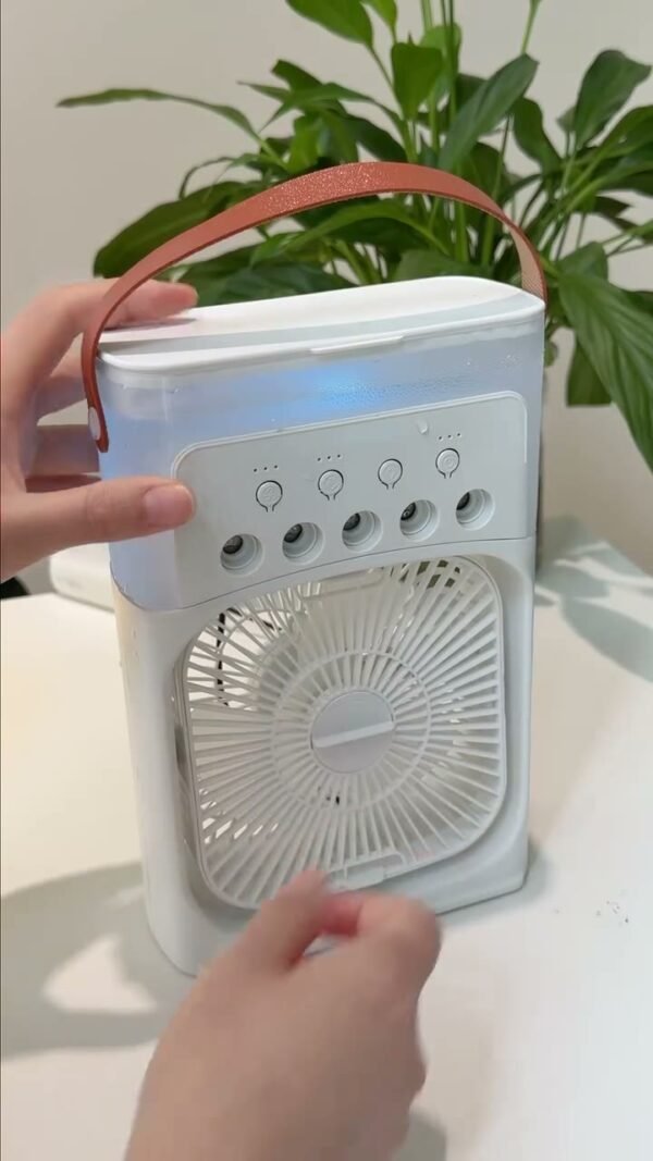 Portable mist cooling fan being used on a desk