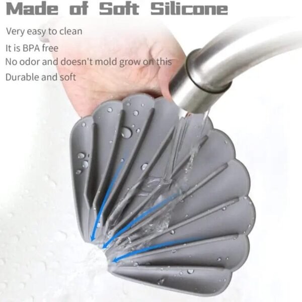 Shell shaped soap holder made of soft silicone under a tap
