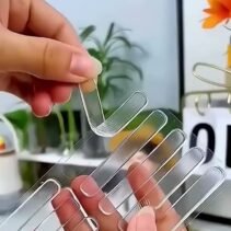 Hands holding the pack of clear safety tape strips