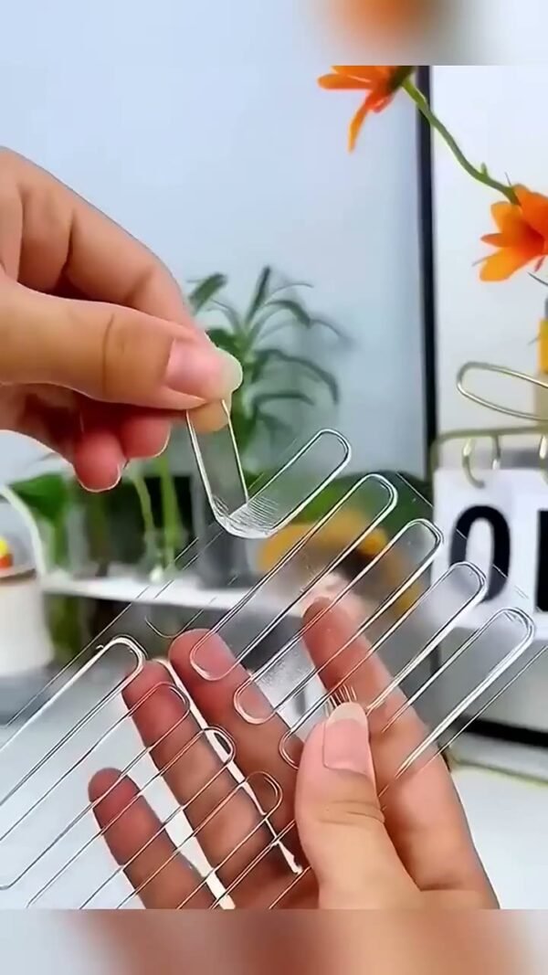 Hands holding the pack of clear safety tape strips