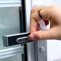 Clear sealing strip being applied on a door handle edge