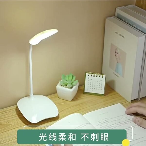 Flexible white LED study lamp lighting an open book