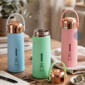 Nice vacuum flask bottles in blue green and pink on a table