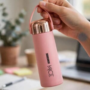 Pink vacuum flask bottle with carry loop held in hand