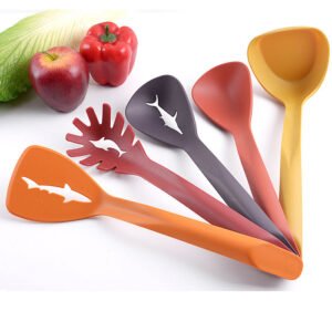 Five piece colourful serving spoons laid out with vegetables