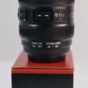 Lens design coffee mug standing on its box