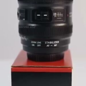 Lens design coffee mug standing on its box