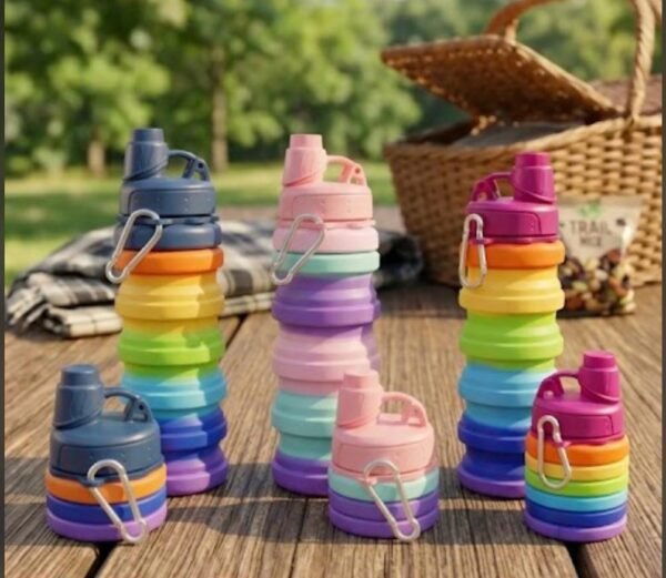 Rainbow collapsible silicone water bottles on a picnic table