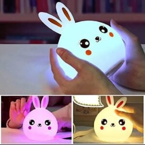 Cute bunny night light glowing blue held in hands