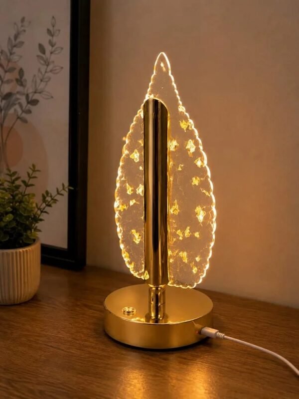 Leaf design crystal table lamp glowing on a side table