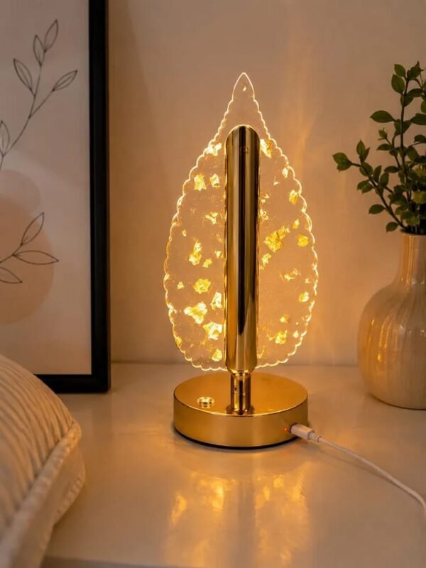 Golden leaf crystal lamp on a bedside table