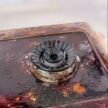 Greasy stove burner before bubble cleaner treatment
