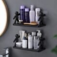 Two wall shelves with human figure brackets in a bathroom
