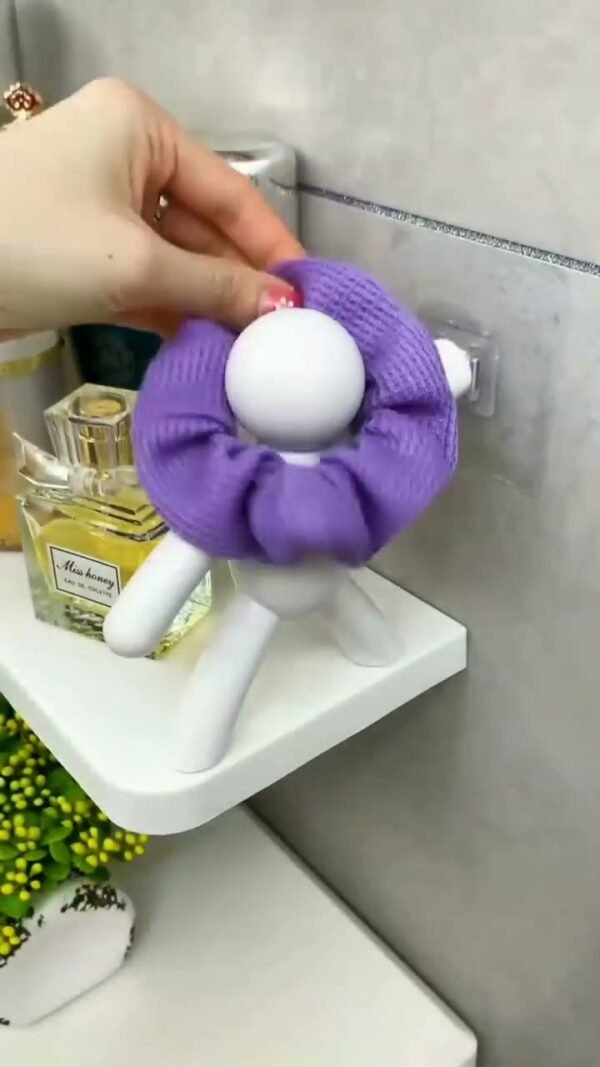 Human figure shelf bracket holding a bath sponge in use