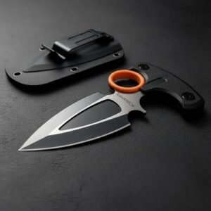Tactical push knife with black T-handle and orange finger ring next to its box