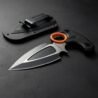 Tactical push knife with black T-handle and orange finger ring next to its box