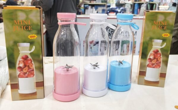 Portable juicer blender bottles in pink, white and blue with boxes