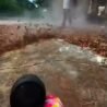 Cordless jet blower in action blowing dust and leaves off the ground