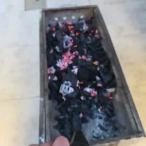 Turbo jet dust blower in hand blowing air over barbecue charcoal